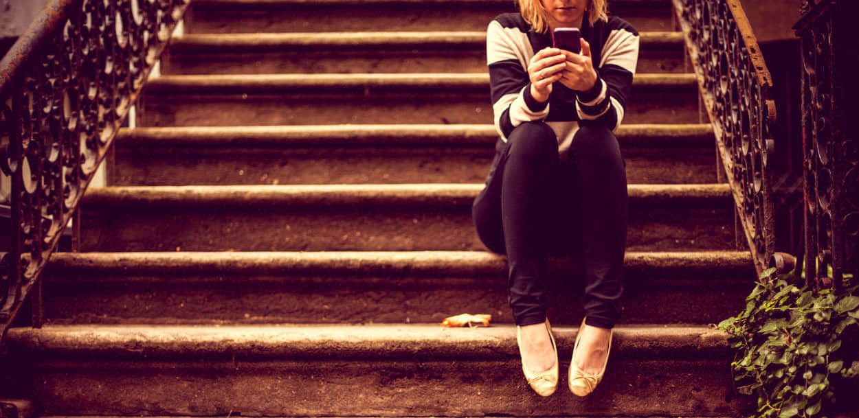 A buyer reviews listings on her phone — the home-buying journey starts long before the first viewing.