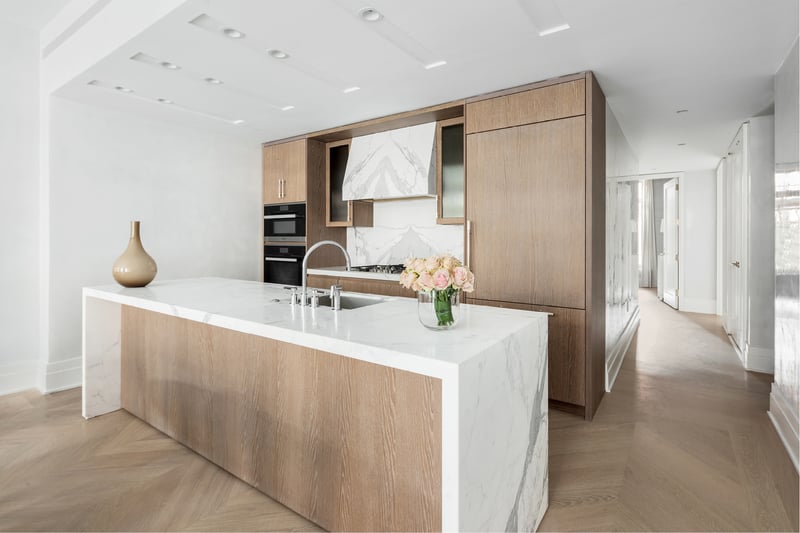 40 Bleecker chef's kitchen with marble island and oak cabinetry