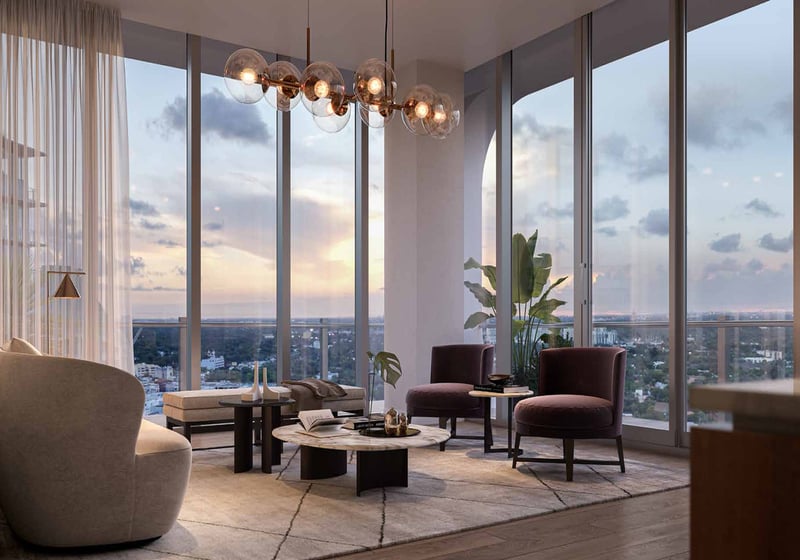 Mr. C Residences living room with floor-to-ceiling windows and bay views