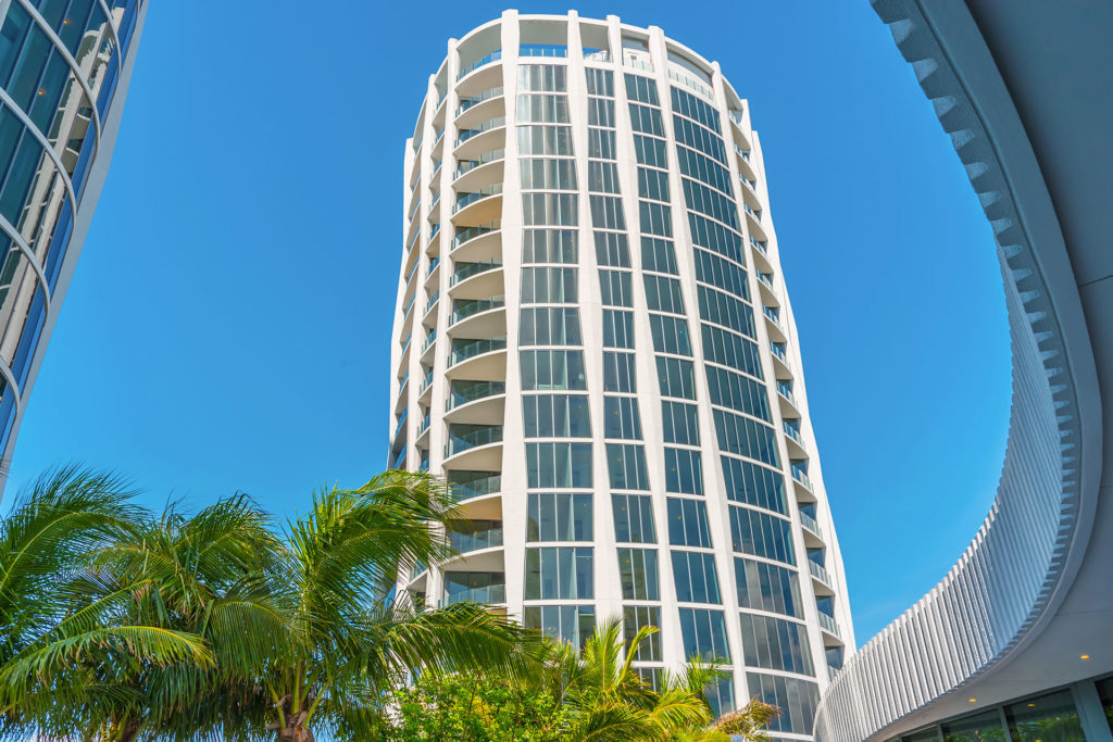 Curved glass and concrete facade at One Park Grove in Coconut Grove