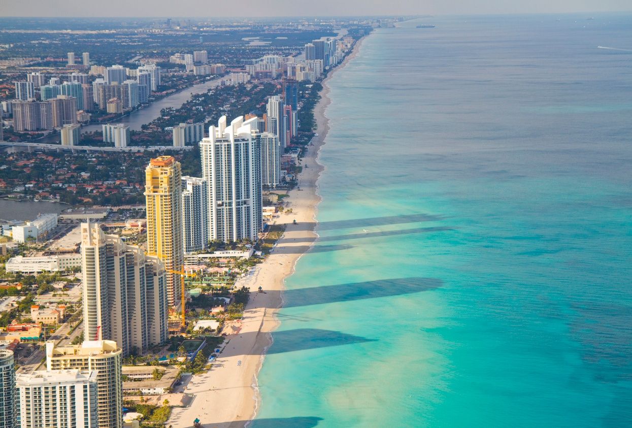 an overhead view of high-rise condo buildings along Miami Beach