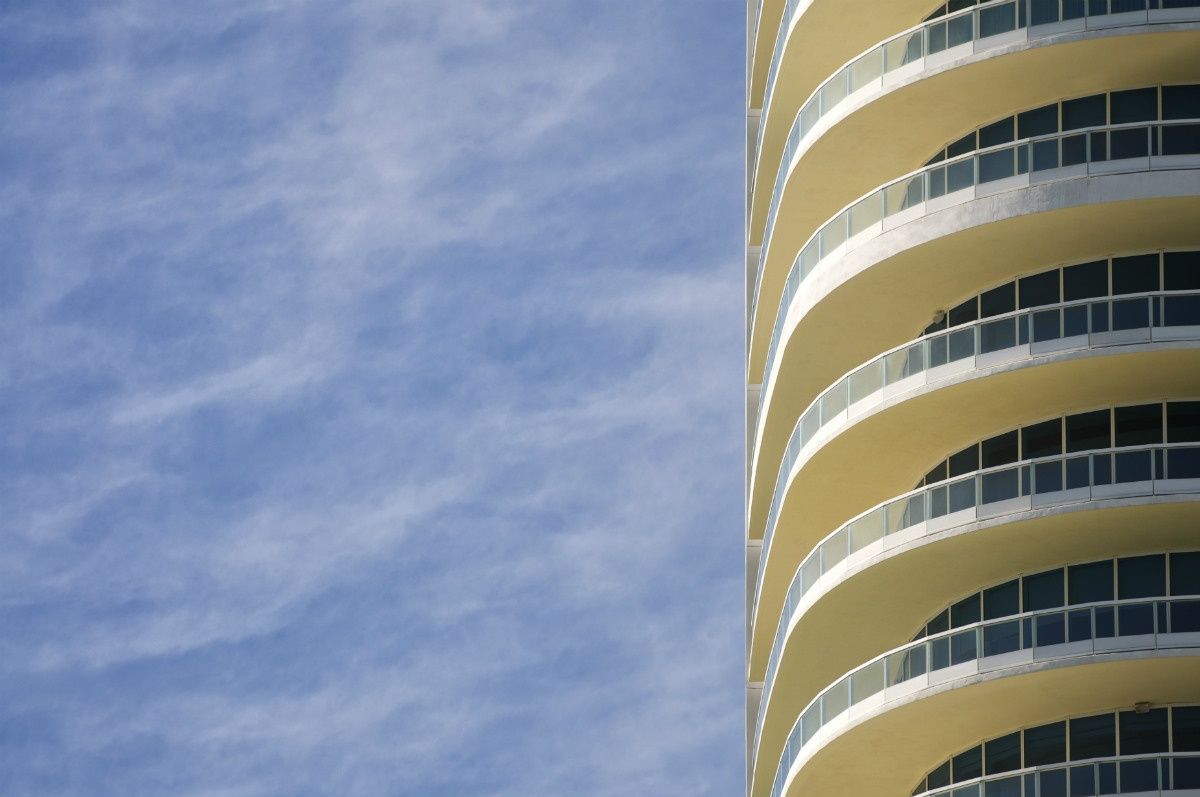 Curved glass terraces on the Continuum South Beach facade