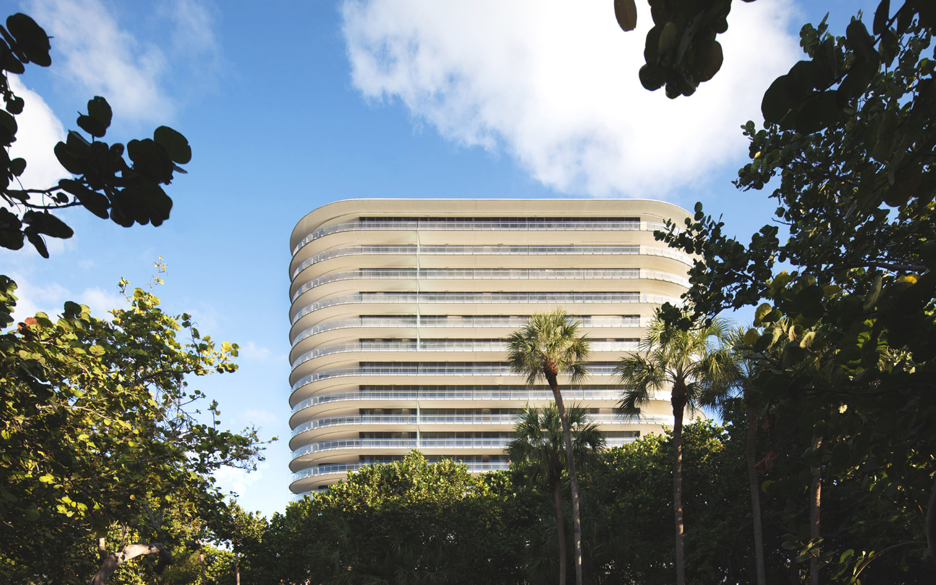 Eighty Seven Park framed by mature trees and tropical landscaping