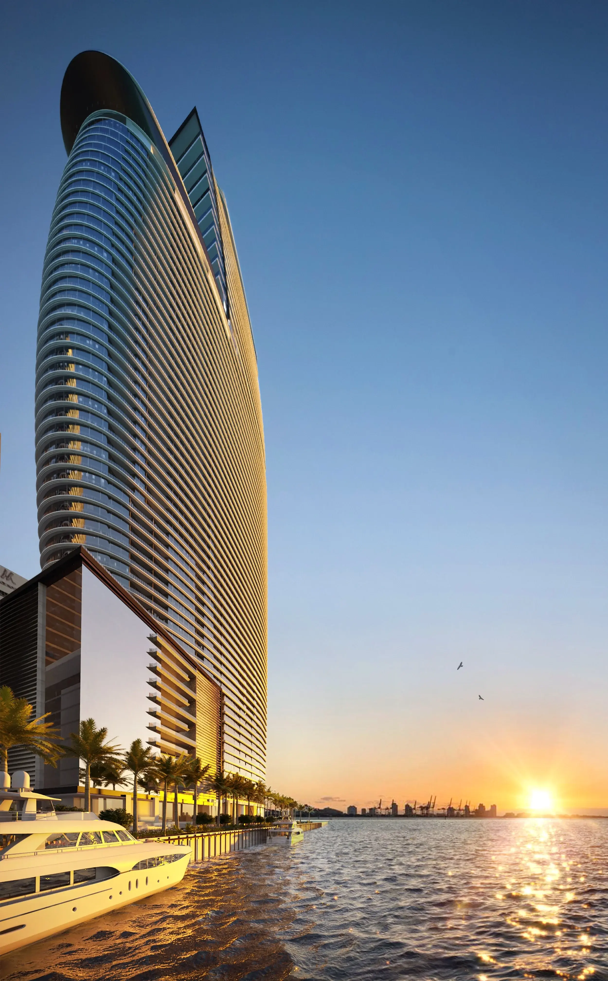 Aston Martin Residences rising above the Miami River at sunset